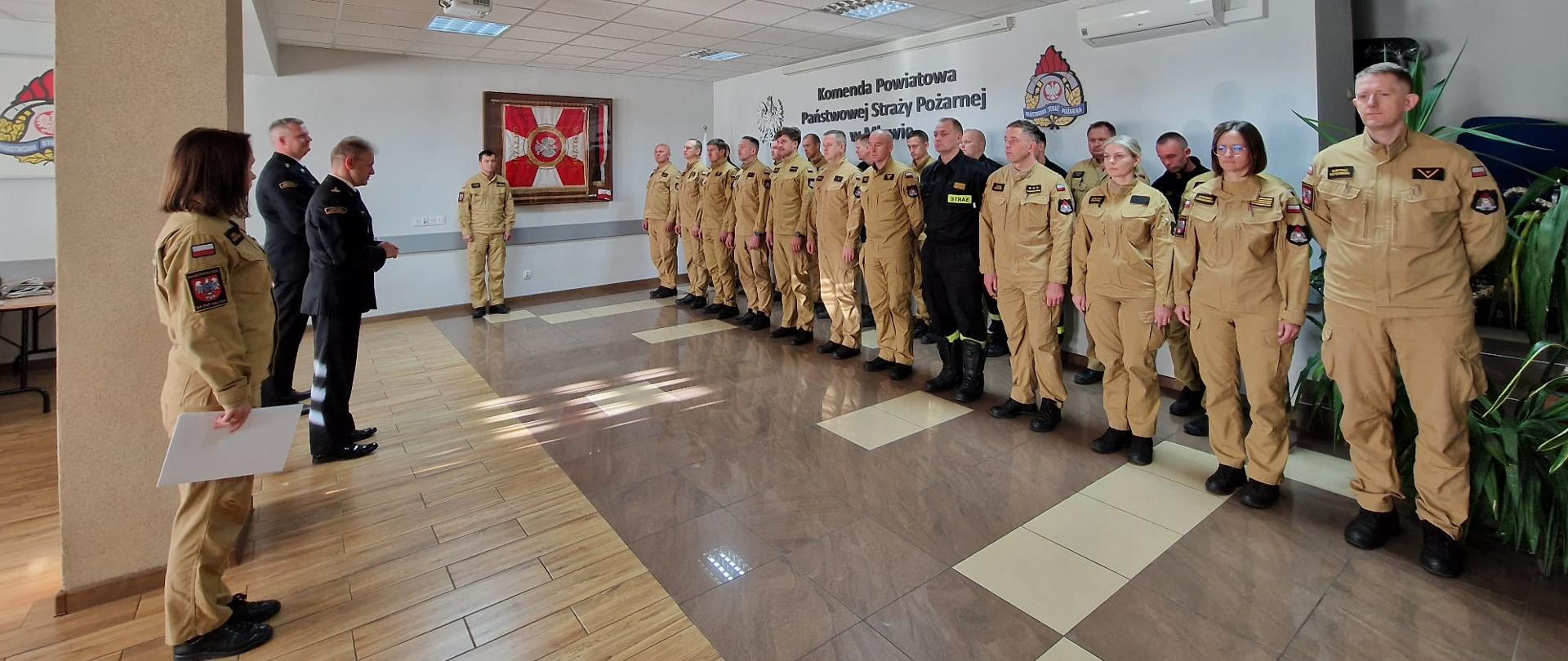 Komendant Powiatowy PSP w Mławie, st. bryg. Jarosław Andruszkiewicz, podczas przemówienia do funkcjonariuszy zgromadzonych na uroczystej zbiórce z okazji awansów i wyróżnienia.