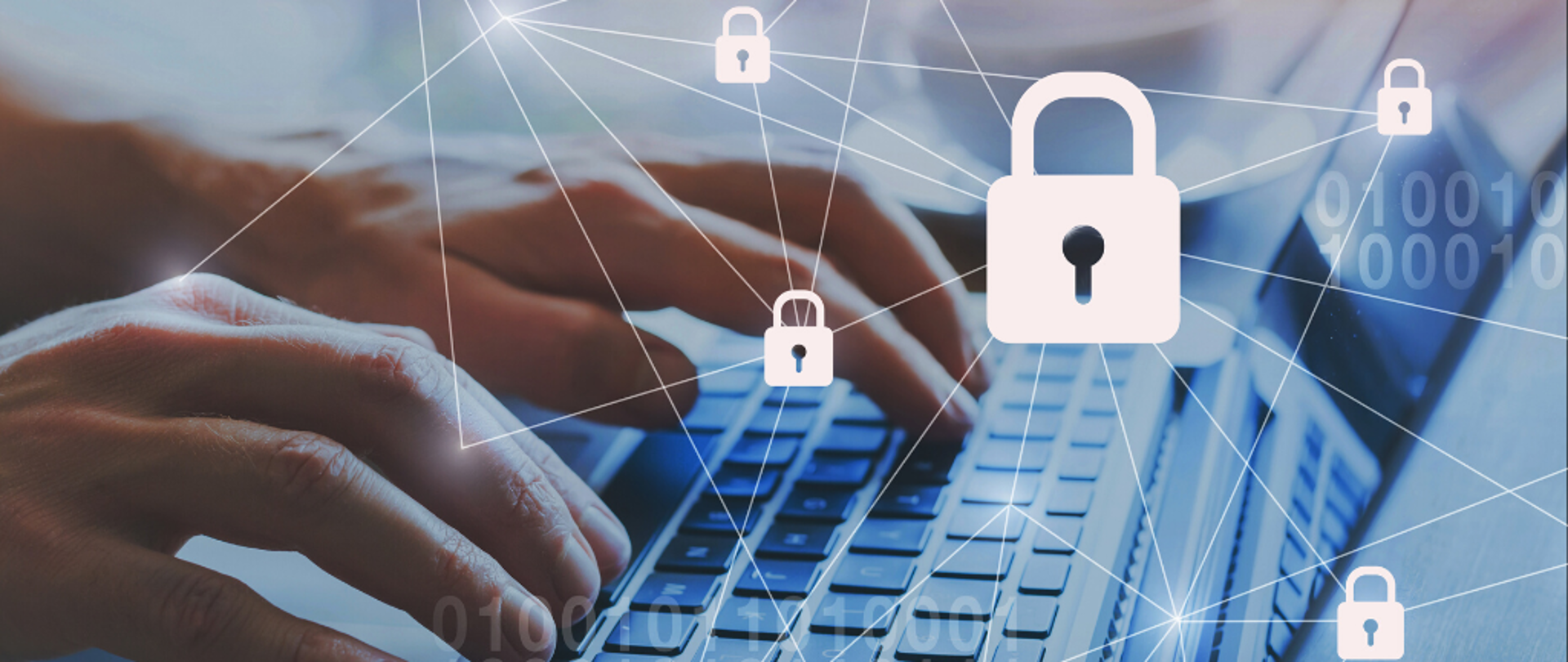 kłódki połączone sieciami, a w tle dłonie na klawiaturze laptopa