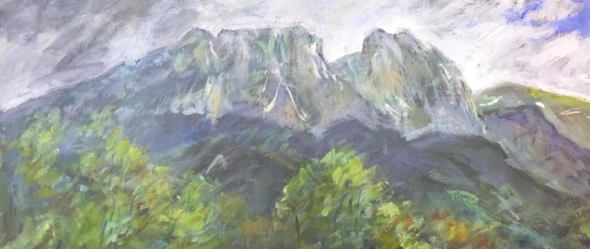Na zdjęciu przedstawiony jest obraz olejny namalowany przez słowackiego artystę malarza Stano Laydę. Na pierwszym planie obrazu zielona łąka, następnie namalowane są drzewa i krzewy. Na drugim planie przedstawione są zbocza gór z zieloną kosówką. Na trzecim planie namalowany jest szczyt Giewontu w błękitnych chmurach.