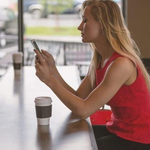 Kobieta przy kawie ze smartfonem