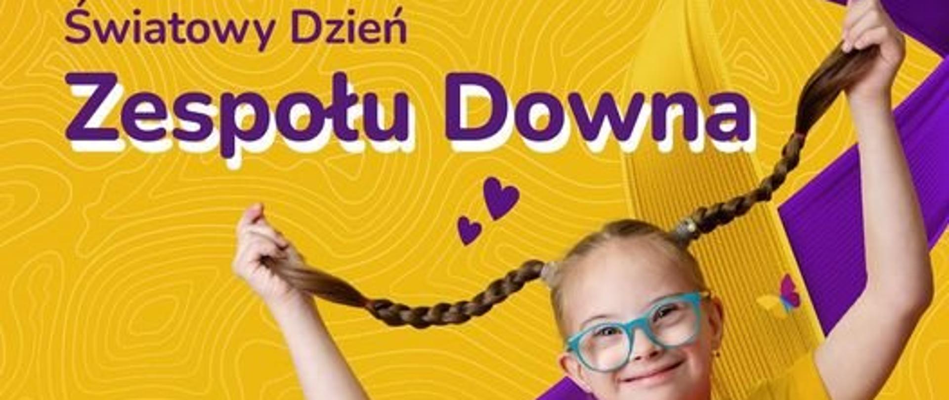 Na żółtym tle umieszczono napis "21 marca - Światowy Dzień Zespołu Downa" poniżej zdjęcie uśmiechniętej dziewczynki w okularach trzymającej warkocze na tle żółto-fioletowej wstęgi. W dolnej części umieszczono napis "Widzimy Was wspieramy i doceniamy!". W prawym dolnym rogu umieszczono logo Ministerstwa Zdrowia oraz Państwowej Inspekcji Sanitarnej. 