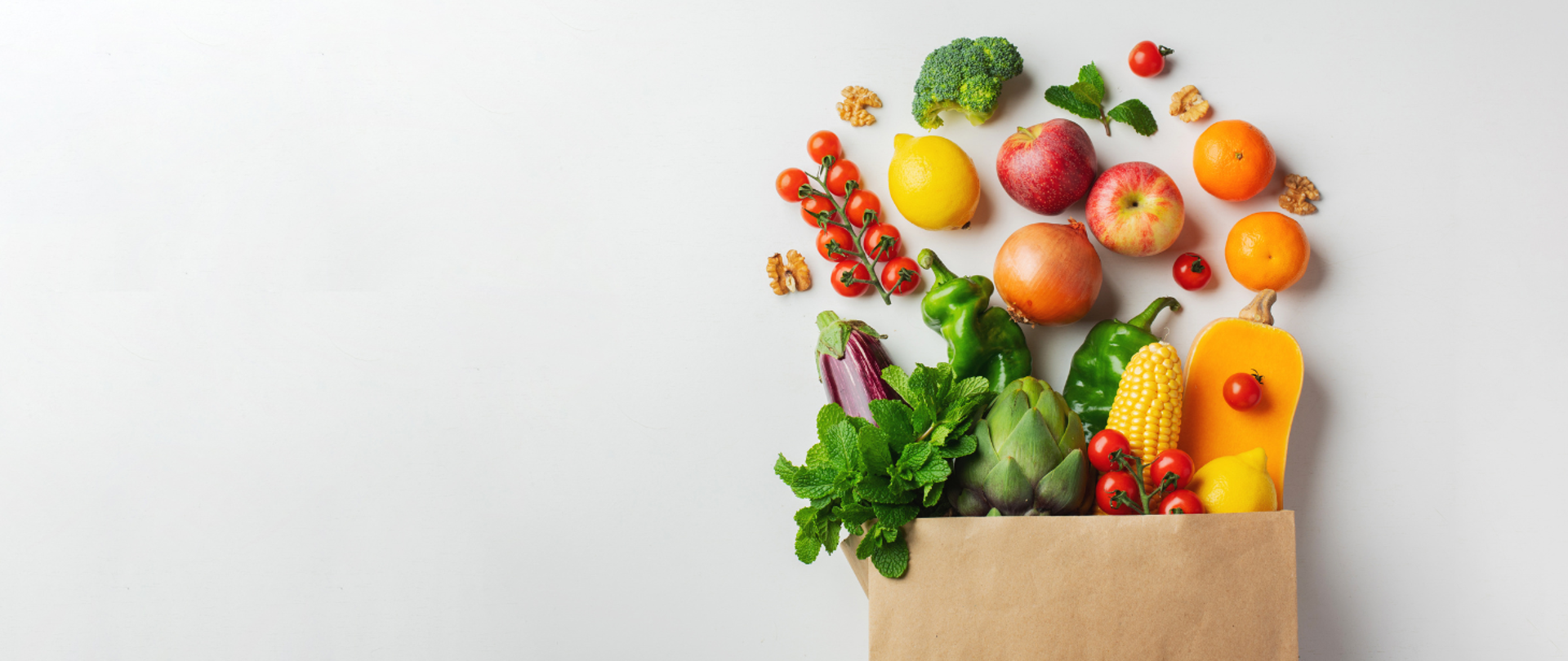 Grafika przedstawiająca papierową torbę z zakupami spożywczymi.