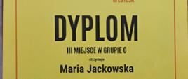 Na żółtym tle czarne litery Dyplom III miejsce w grupie C