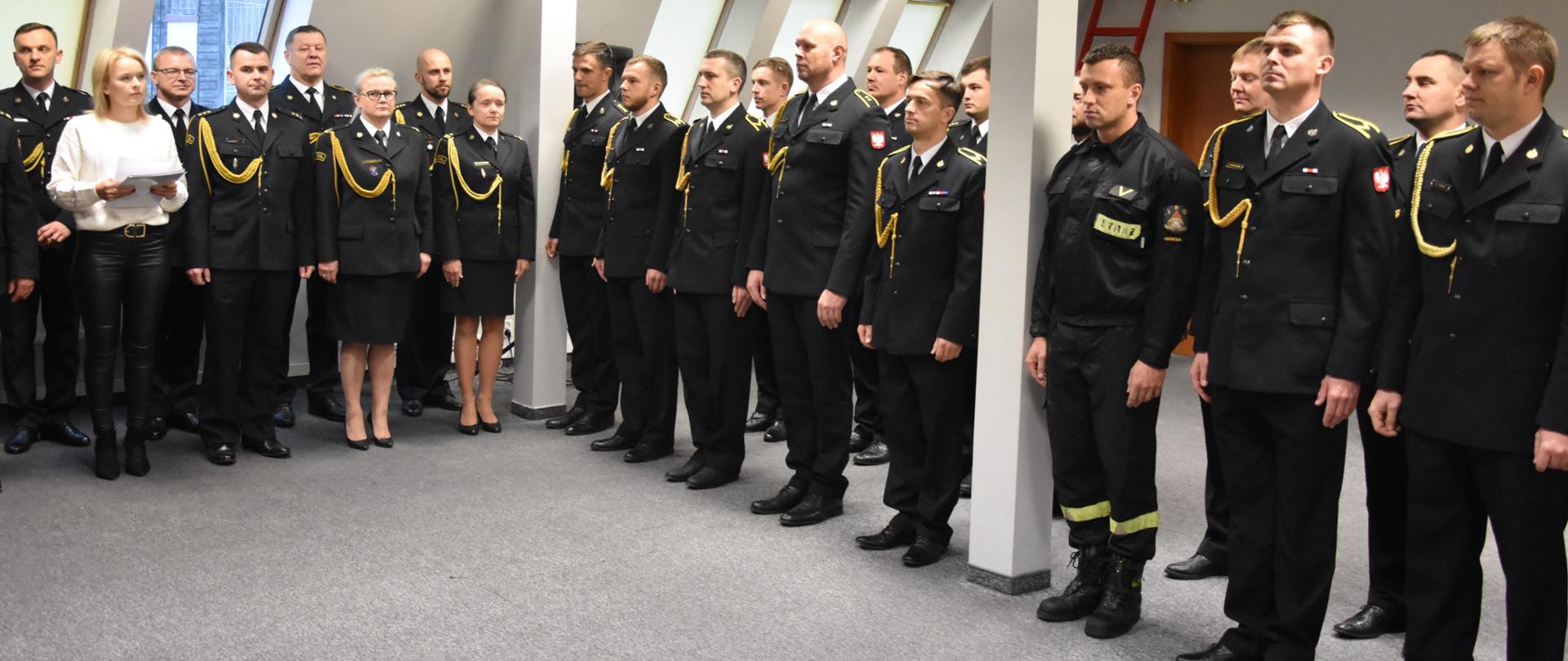 Strażacy stojący na zbiórce w umundurowaniu galowym