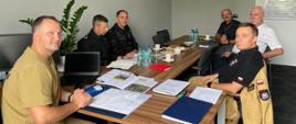 4 funkcjonariuszy KG PSP oraz dwóch inżynierów AIRBIUS Poland S.A. siedzą przy stole podczas rozmów