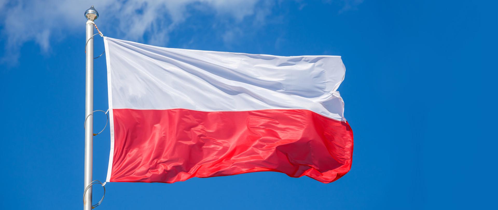 Polish flag on blue sky background