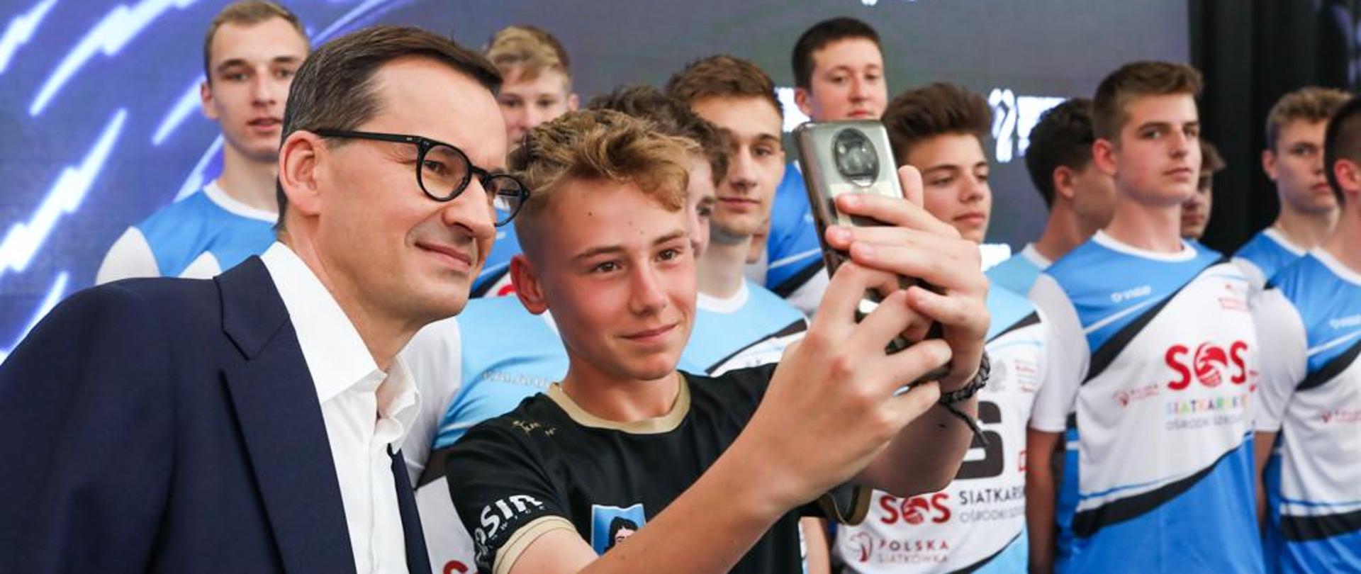 Prime Minister Mateusz Morawiecki during a joint photo with athletes as part of the announcement of the cities hosting the Finals of the Men's Volleyball World Championship 2022