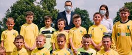 Wspólne zdjęcie premiera Mateusza Morawieckiego, minister sportu i młodych piłkarzy.