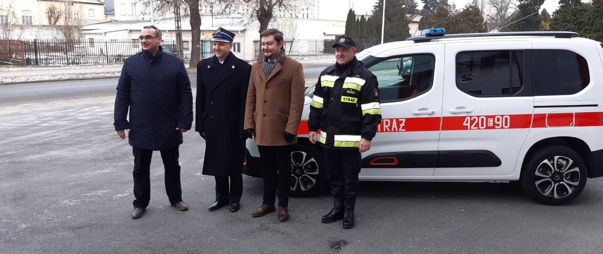 Przed Komendą Powiatową Państwowej Straży Pożarnej na tle nowego samochodu operacyjnego koloru białego stają od prawej: Dowódca JRG w Kutnie mł. bryg. Mariusz Jagodziński, Starosta Kutnowski Daniel Kowalik, Komendant Powiatowy Państwowej Straży Pożarnej w Kutnie st. bryg. Marek Myszkowski i Radny Powiatu Kutnowskiego Tomasz Walczewski.