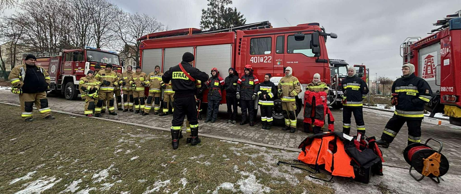 Zdjęcie przedstawia ćwiczenia strażaków na lodzie z udziałem sań lodowych
