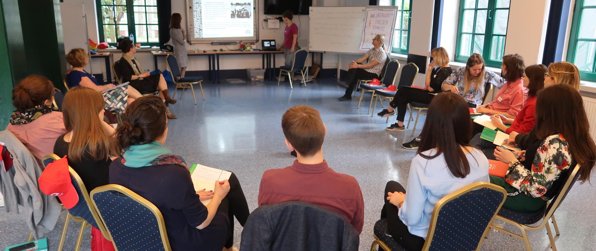 A group of students sitting in the circle