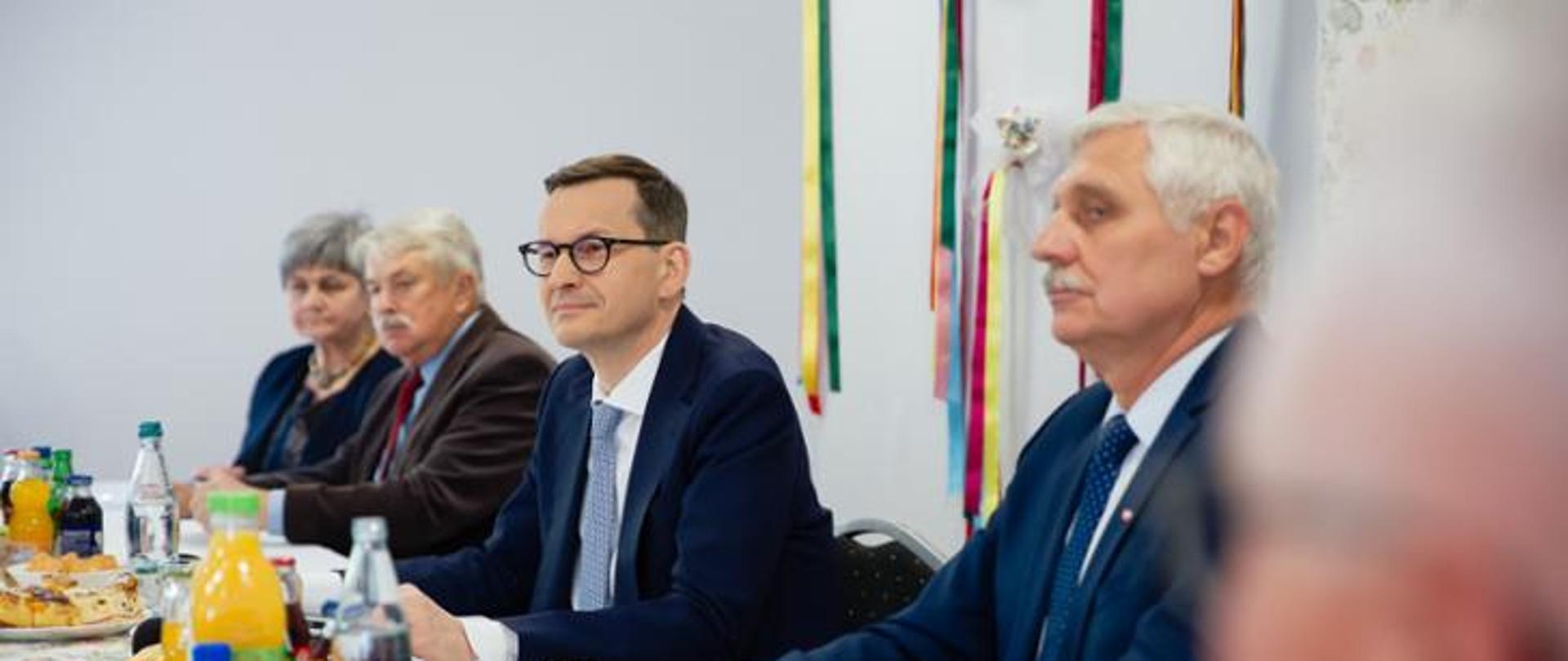 Kilka osób siedzących przy stole