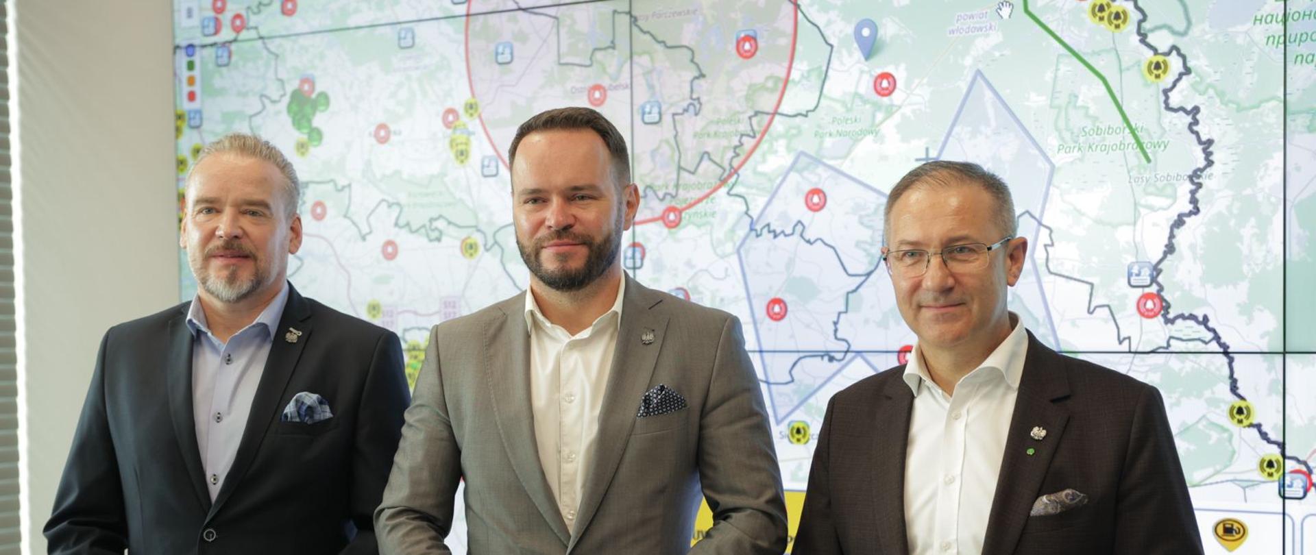 Od lewej: wicewojewoda Wojciech Wołoch, wojewoda Krzysztof Komorski i wicewojewoda Andrzej Maj na tle interaktywnej mapy.