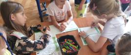 dzieci z kolorowankami dot. profilaktyki chorób odkleszczowych