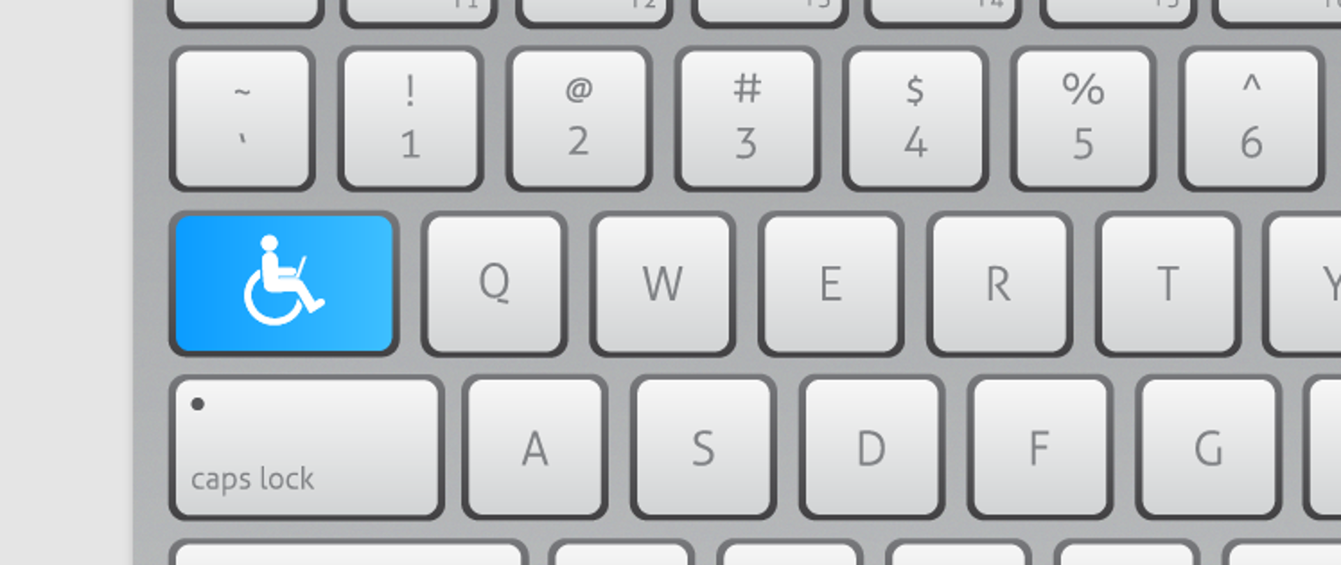 Na zdjęciu widzimy klawiaturę, na jednym z przycisków w kolorze niebieskim narysowana jest osoba na wózku inwalidzkim