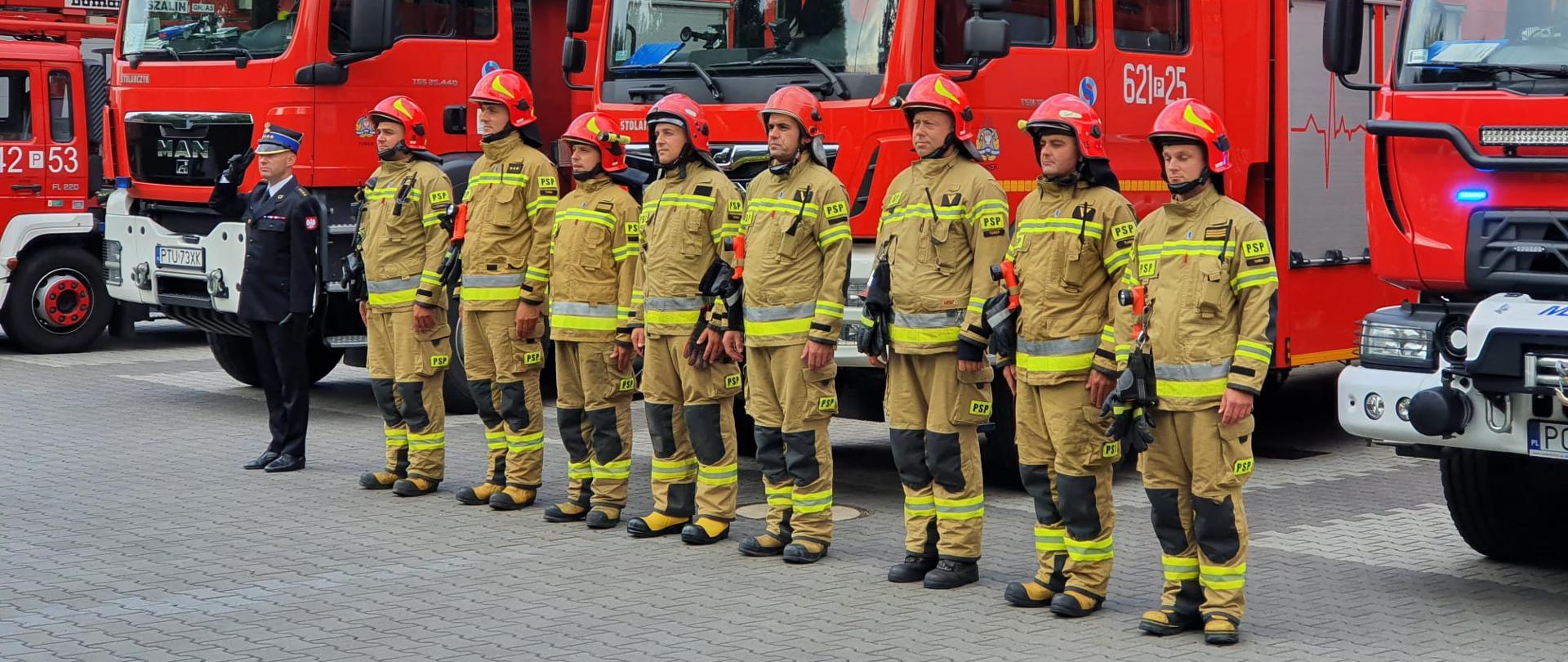 Zmiana służbowa w trakcie uczczenia 78 rocznicy wybuchu Powstania Warszawskiego na tle samochodów pożarniczych.