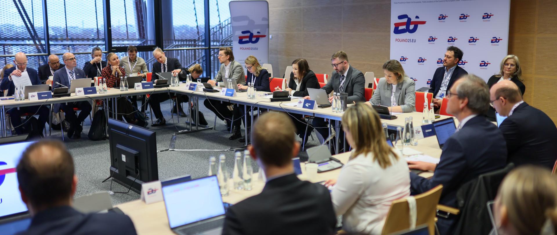 Uczestnicy wydarzenia siedzą wokół stołu
