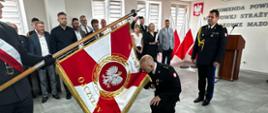 Moment przywitania nowego komendanta ze sztandarem komendy. W tle zaproszeniu goście