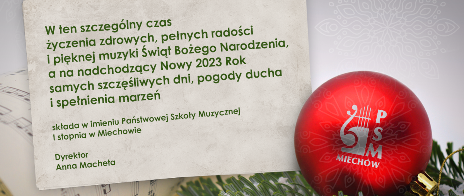 Grafika przedstawia czerwoną bombkę z logo szkoły, w tle znajduje się gałązka świerku oraz życzenia w formie tekstowej