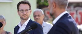Minister rozwoju i technologii Waldemar Buda na konferencji prasowej w Zgierzu nt. propozycji MRiT, która rozwiąże ponad 30-letni problem najemców byłych mieszkań pracowniczych, minister stoi przy mikrofonie, po jego prawej stronie stoi prezydent Zgierza Przemysław Staniszewski