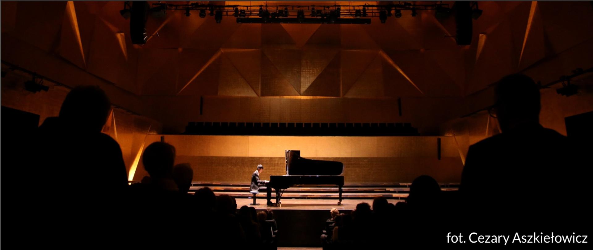 Zdjęcie przedstawia Erica Lu grającego w Złotej Sali Filharmonii w Szczecinie