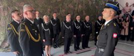 Zastępca Dowódcy Jednostki PSP w Lwówku Śląskim składający meldunek o rozpoczęciu uroczystości dla Zastępcy Komendanta Wojewódzkiego Państwowej Straży Pożarnej we Wrocławiu.