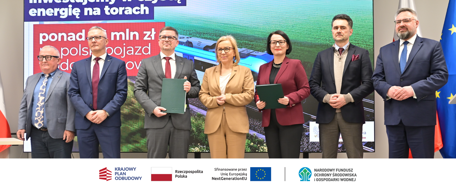 Zdjęcie grupowe. W stopce grafiki ciąg logotypów: Krajowy Plan Odbudowy, flaga Rzeczypospolita Polska, flaga UE Sfinansowane przez UE NextGenerationUE, NFOŚiGW.