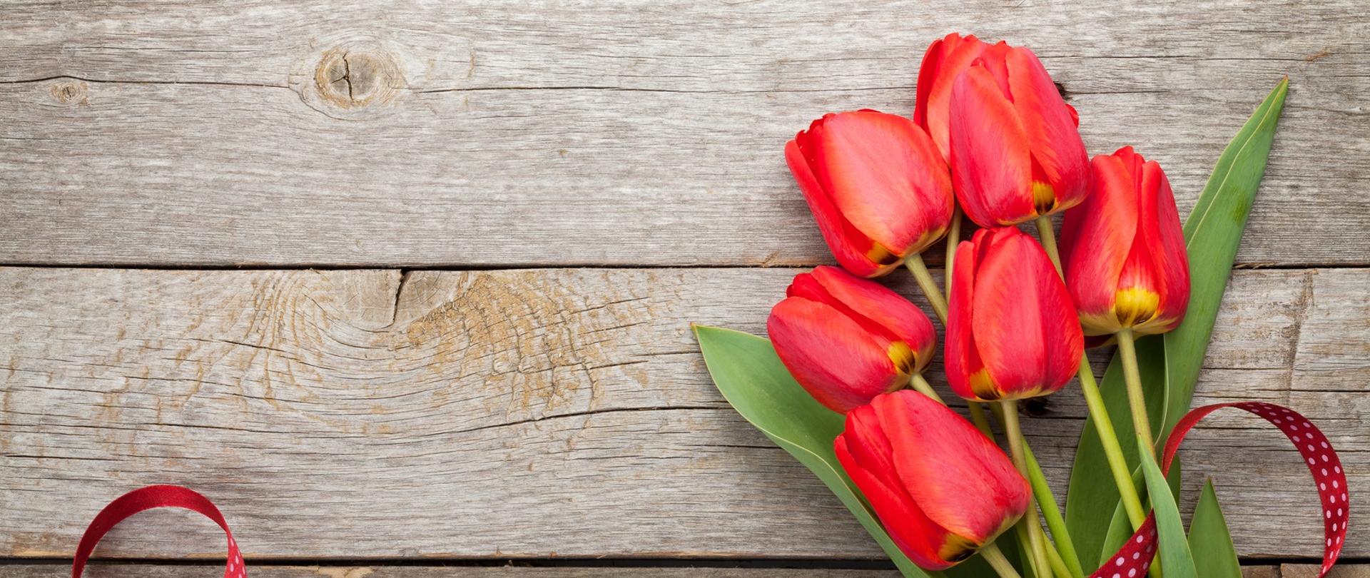 Fresh tulips bouquet over wooden table background