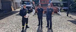 Zdjęcie przedstawia policjantów i strażaka podczas akcji prewencyjnej na temat bezpiecznych żniw.