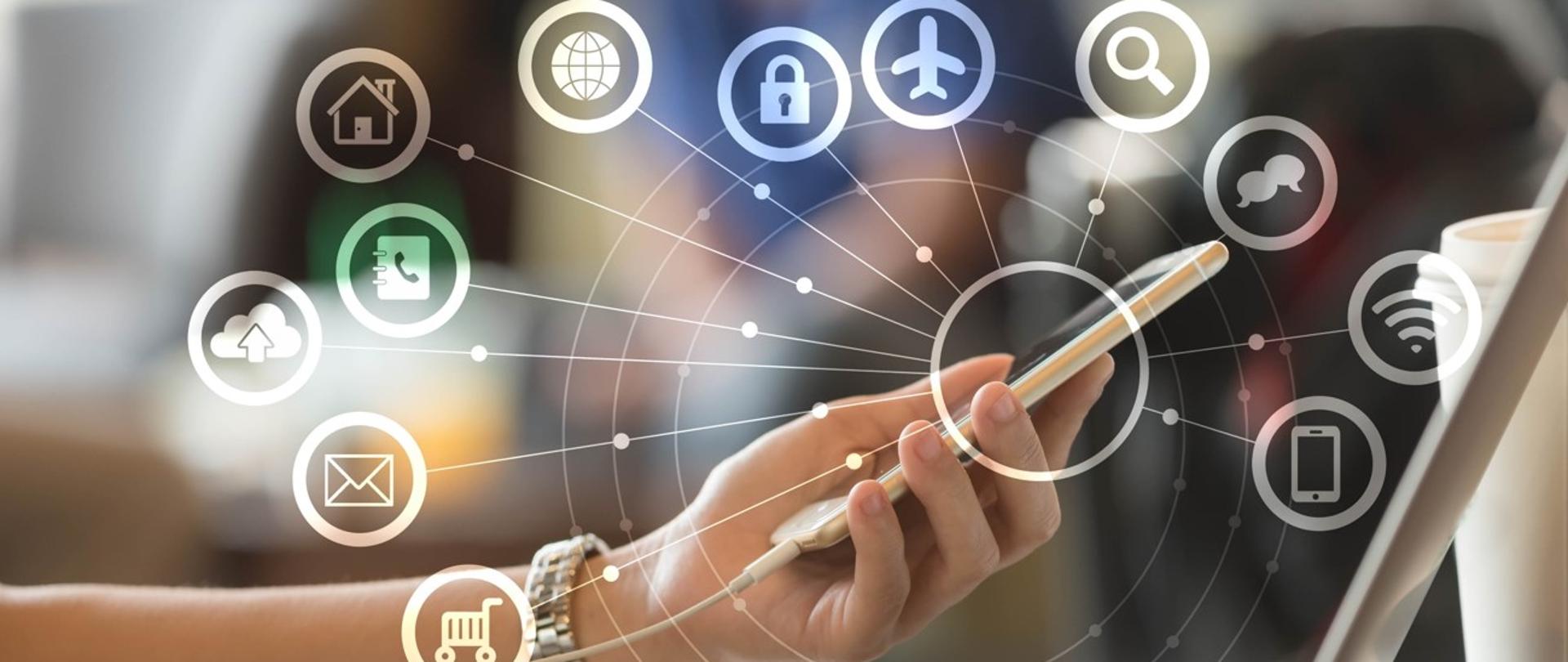 grafika symboliczna ręce trzymają telefon nad laptopem