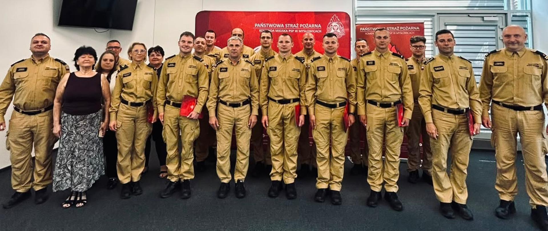 Przedstawiono pamiątkową fotografię całej grupy strażaków oraz zaproszonych gości, wykonaną na zakończenie uroczystej zbiórki w Komendzie Miejskiej PSP w Mysłowicach.
