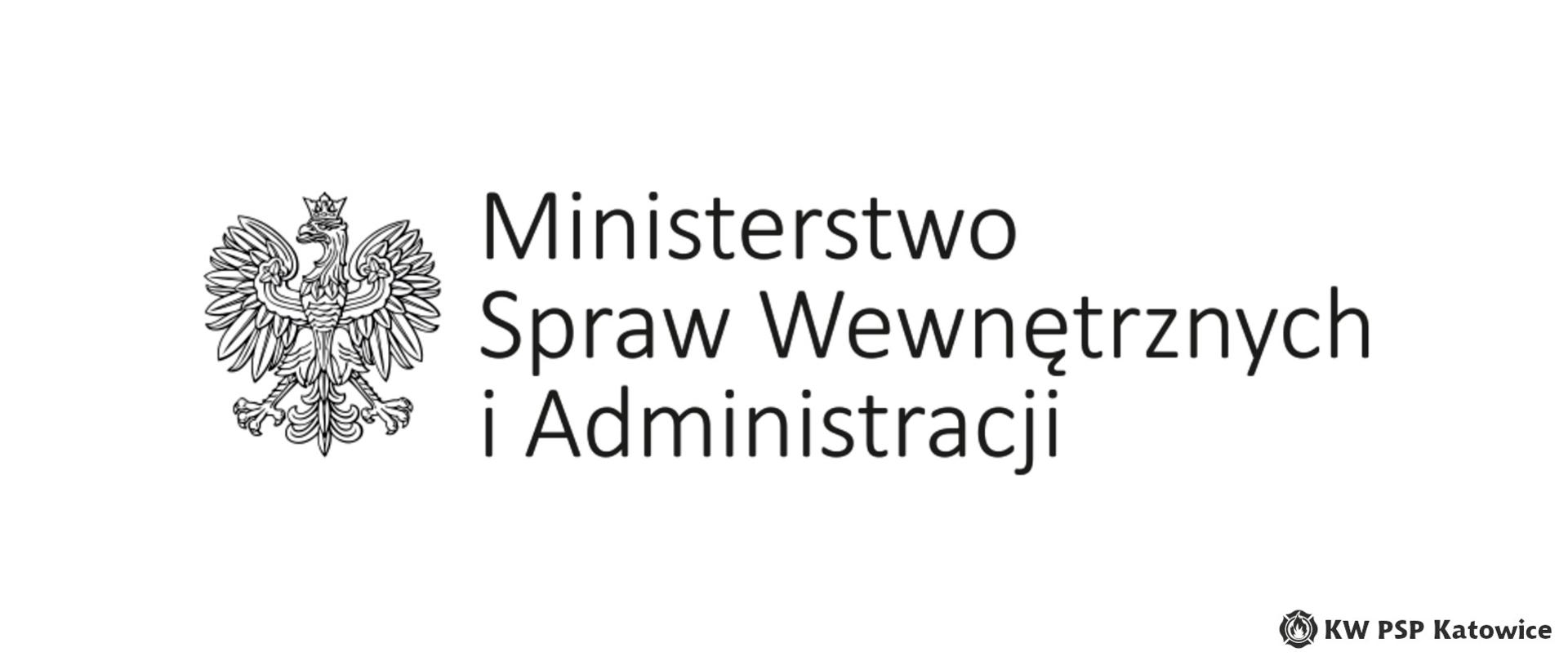 Ilustracja przedstawia na białym tle, na środku czarno-biały logotyp Ministerstwa Spraw Wewnętrznych, który składa się z czarno-białego orła oraz napisu Ministerstwo Spraw Wewnętrznych i Administracji. W prawym dolnym rogu napis KW PSP Katowice
