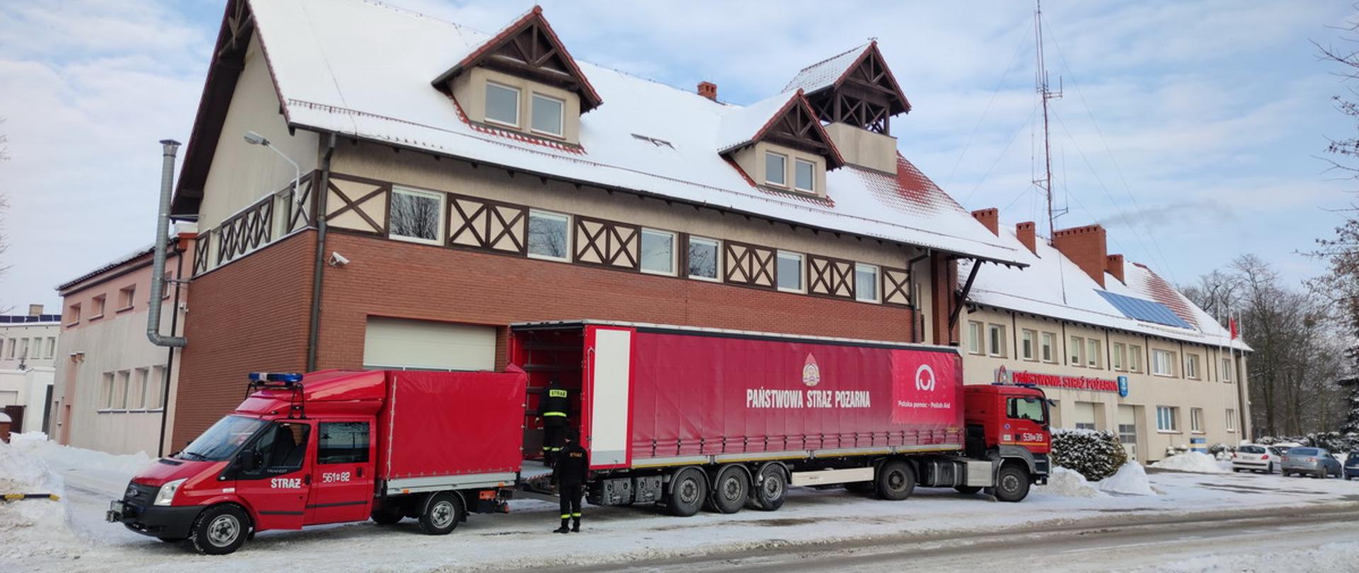 pojazdy pożarnicze stoją przed strażnicą do których pakowane są ulotki
