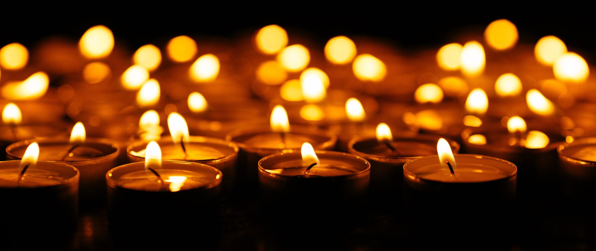 Candles. Set of lighting candles in dark. Selective focus