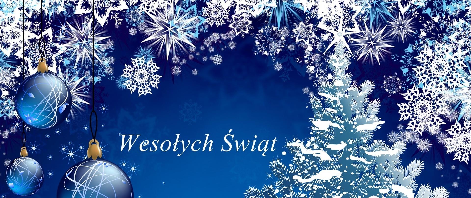 Zdjęcie przedstawia kartkę bożonarodzeniową koloru niebieskiego, choinkę i bombki oraz napis wesołych świąt