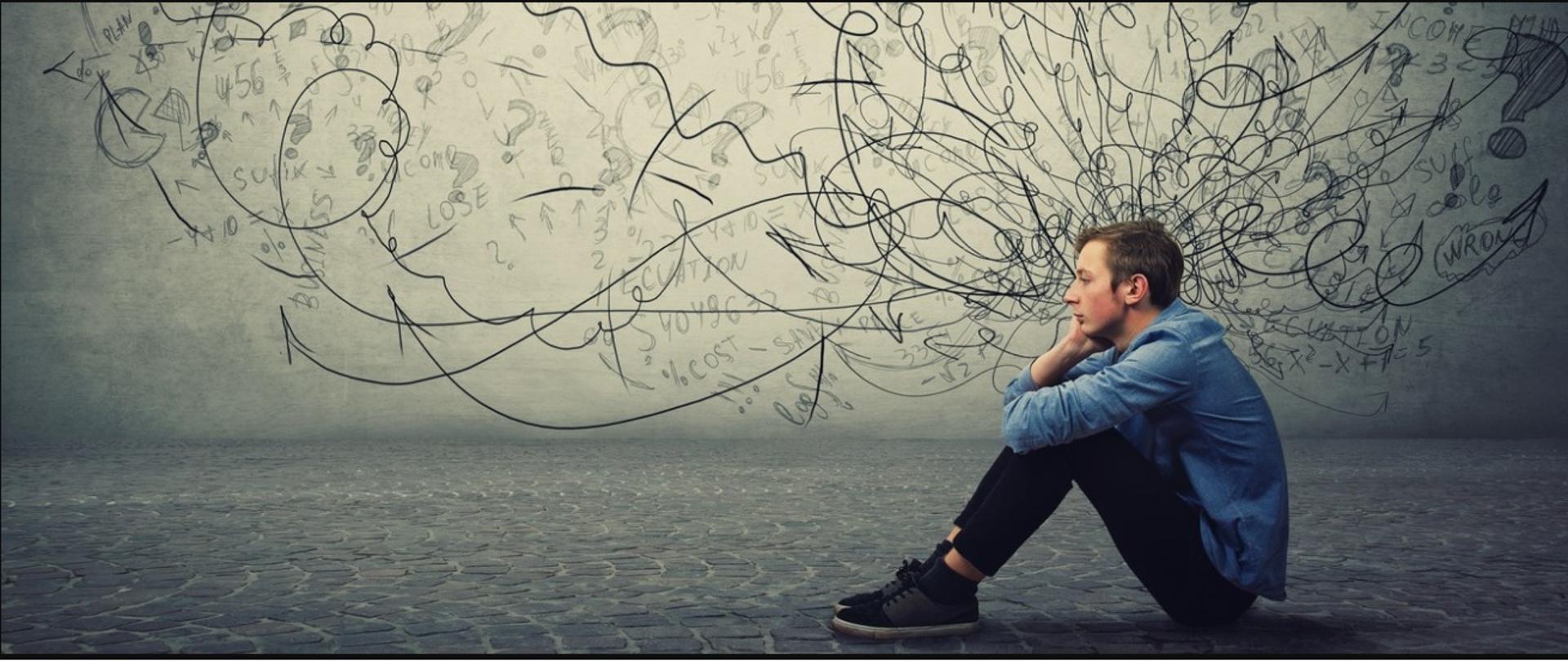 Na obrazku przedstawiony jest siedzący na bruku nastoletni, smutny chłopiec., który jest zamyślony. Za nim widoczne są kłębiące się myśli, pełne znaków zapytania.