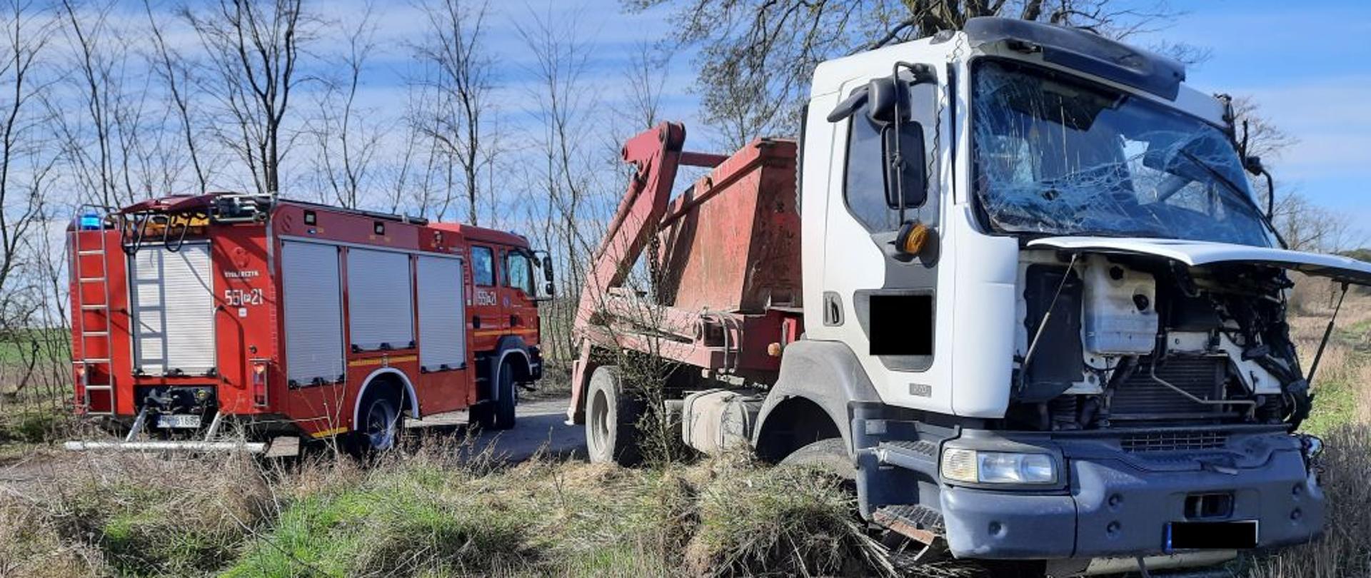 Na zdjęciu widnieje samochód ciężarowy po uderzeniu w drzewo. 