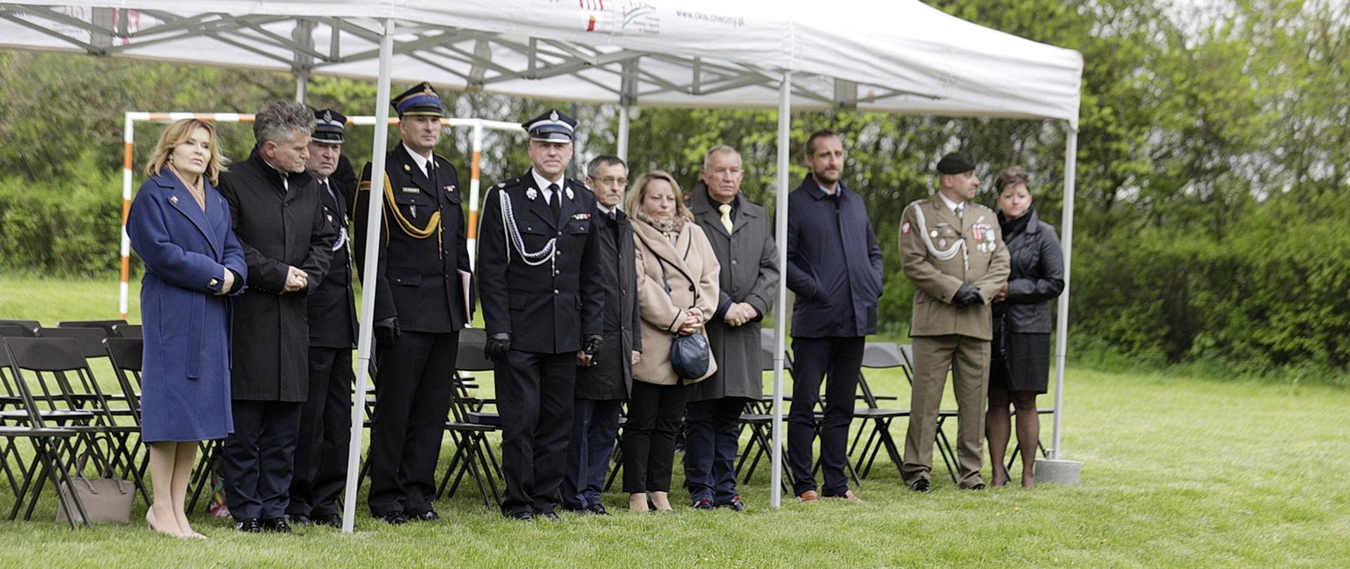 Zdjęcie przedstawia zaproszonych gości oraz organizatorów uroczystości w Łukowej stojących pod rozpiętym namiotem.