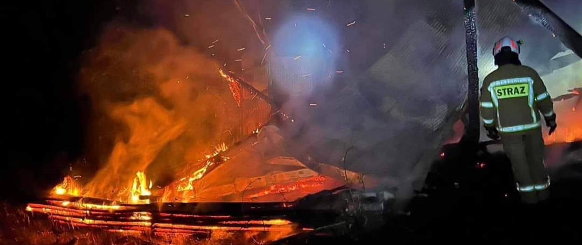 Płomienie na pogorzelisku budynku gospodarczego