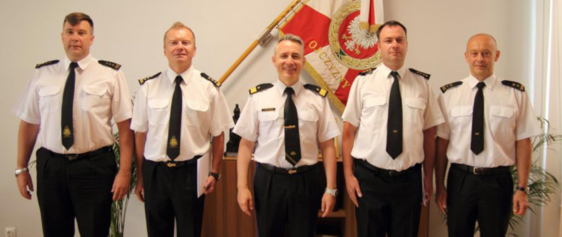 Komendant główny PSP nadbryg. Andrzej Bartkowiak z dniem 1 sierpnia 2020 roku mianował na stanowisko zastępcy dyrektora Biura Kadr i Organizacji Komendy Głównej Państwowej Straży Pożarnej st. bryg. mgr. inż. Rafała Zdziennickiego – zdjęcie zbiorowe wszystkich uczestników uroczystości na tle Sztandaru.