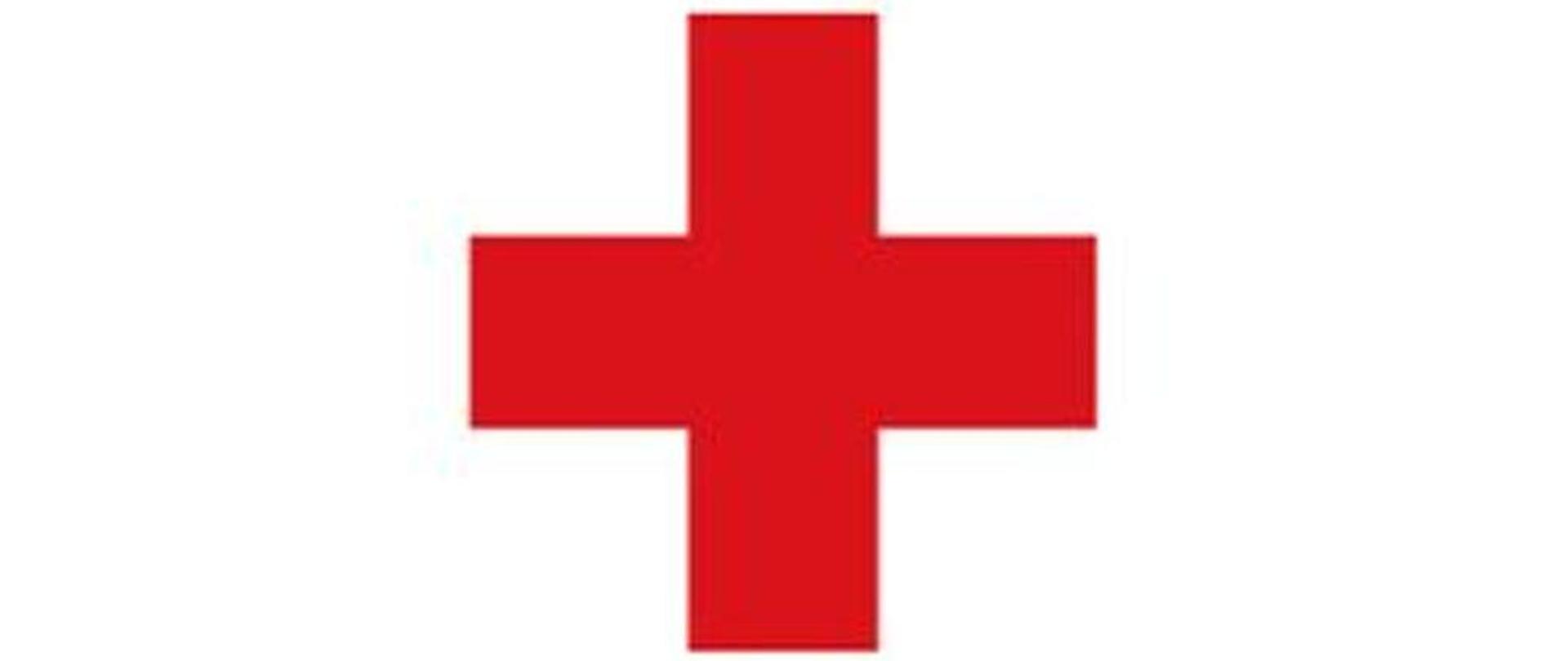Zdjęcie przedstawia czerwony krzyż na białym tle. Symbol Polskiego Czerwonego Krzyża.