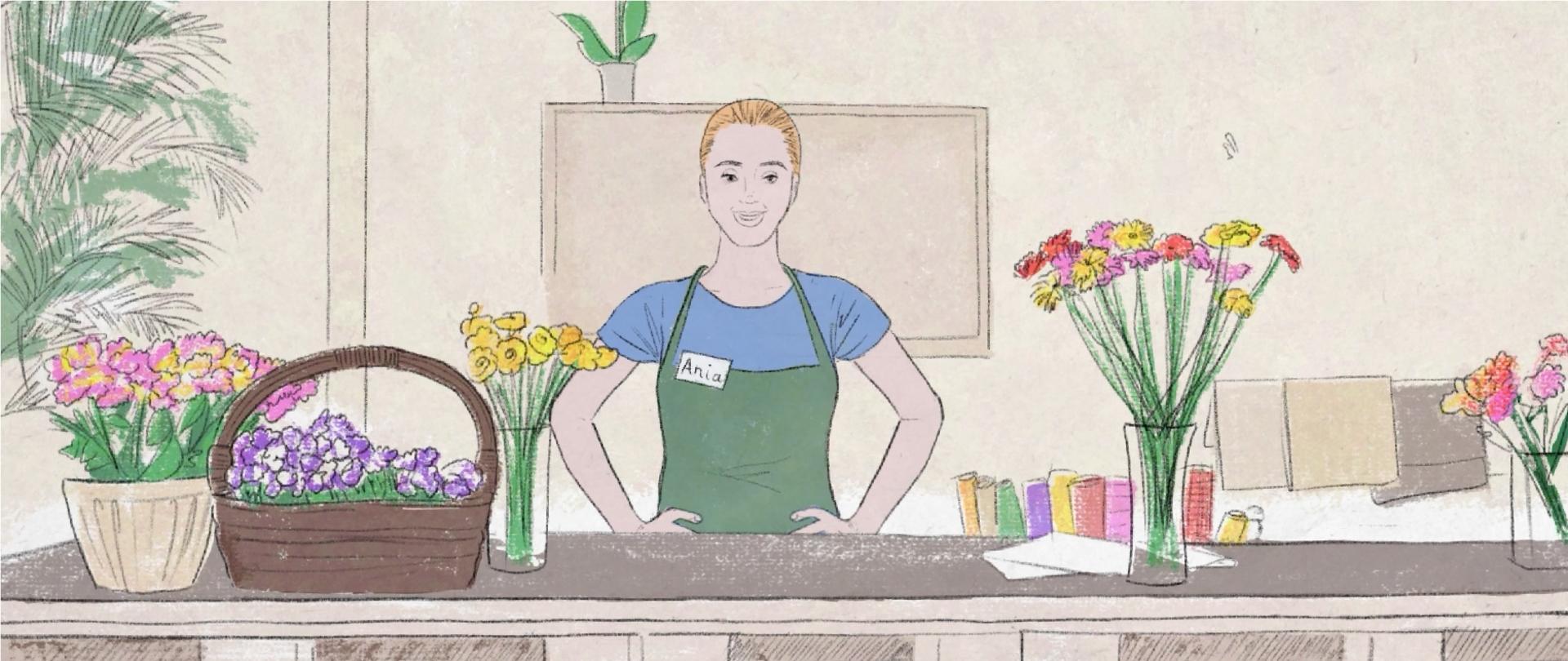 Ania stoi za ladą i okazuje zadowolenie ze zdobycia nowych kompetencji zawodowych