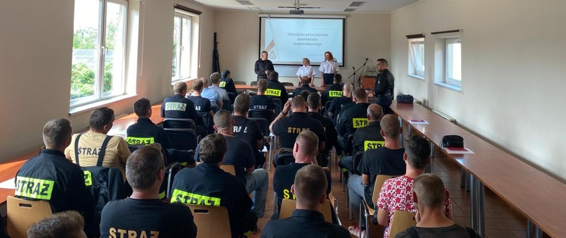 Zdjęcie przedstawia Komendanta Powiatowego oraz przedstawicieli Komendy Wojewódzkiej w Katowicach na sali sztabowej podczas szkolenia druhów OSP