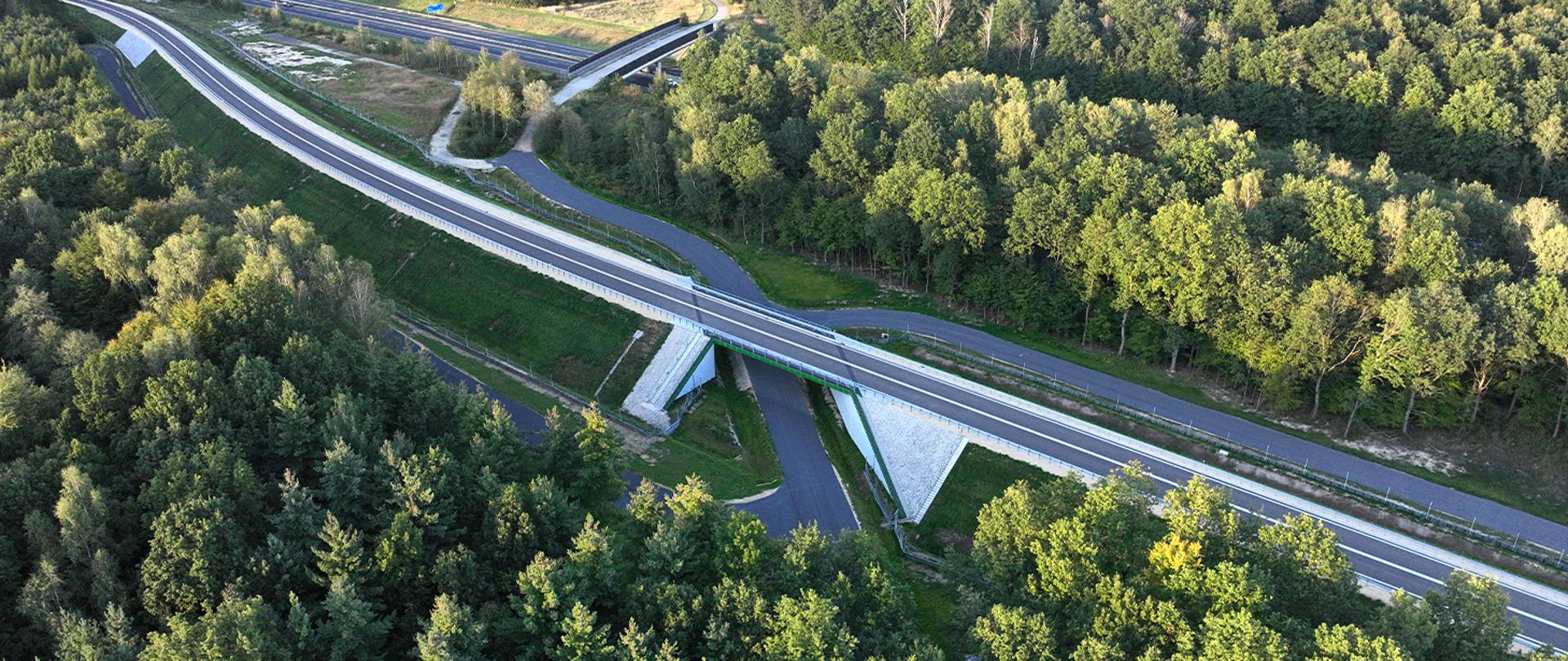 Widok z lotu ptaka na obwodnicę Sośnicowic oddaną do użytkowania, z wiaduktem drogowym przebiegającym nad terenami leśnymi.