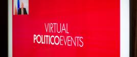 Czerwony ekran monitora na środku napis Virtual Poloticoevents. W lewej minister Tadeusz Kościński