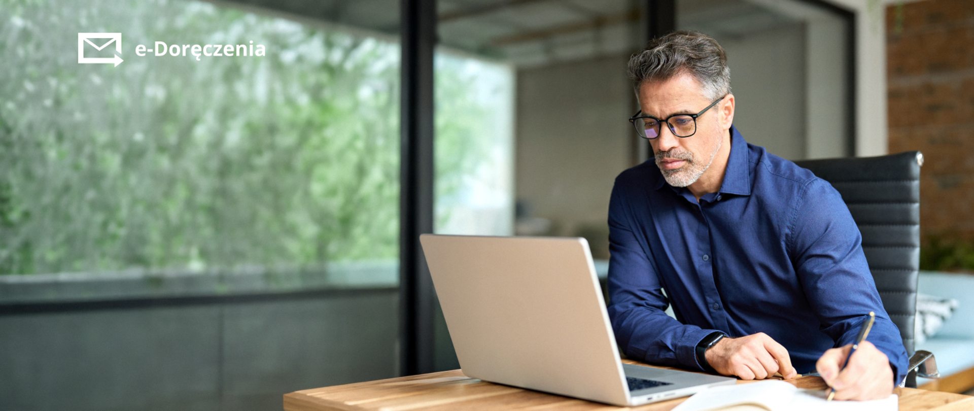 Mężczyzna z laptopem - zaproszenie na webinar dla JST.