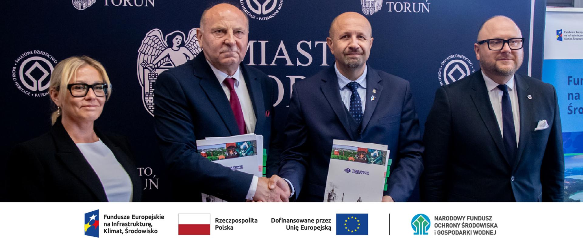 Na zdjęciu do lewej strony: Agnieszka Górzyńska, Członek Zarządu- Zastępca Prezesa Toruńskich Wodociągów Sp. z o. o., Władysław Majewski, Prezes Zarządu Toruńskich Wodociągów Sp. z o. o, Robert Gajda, Zastępca Prezesa Zarządu NFOŚiGW, Paweł Gulewski, Prezydent Miasta Torunia. W stopce zdjęcia ciąg logotypów: Fundusze Europejskie na Infrastrukturę, Klimat, Środowisko, flaga Rzeczypospolita Polska, flaga UE i Dofinansowane przez UE, NFOŚiGW.