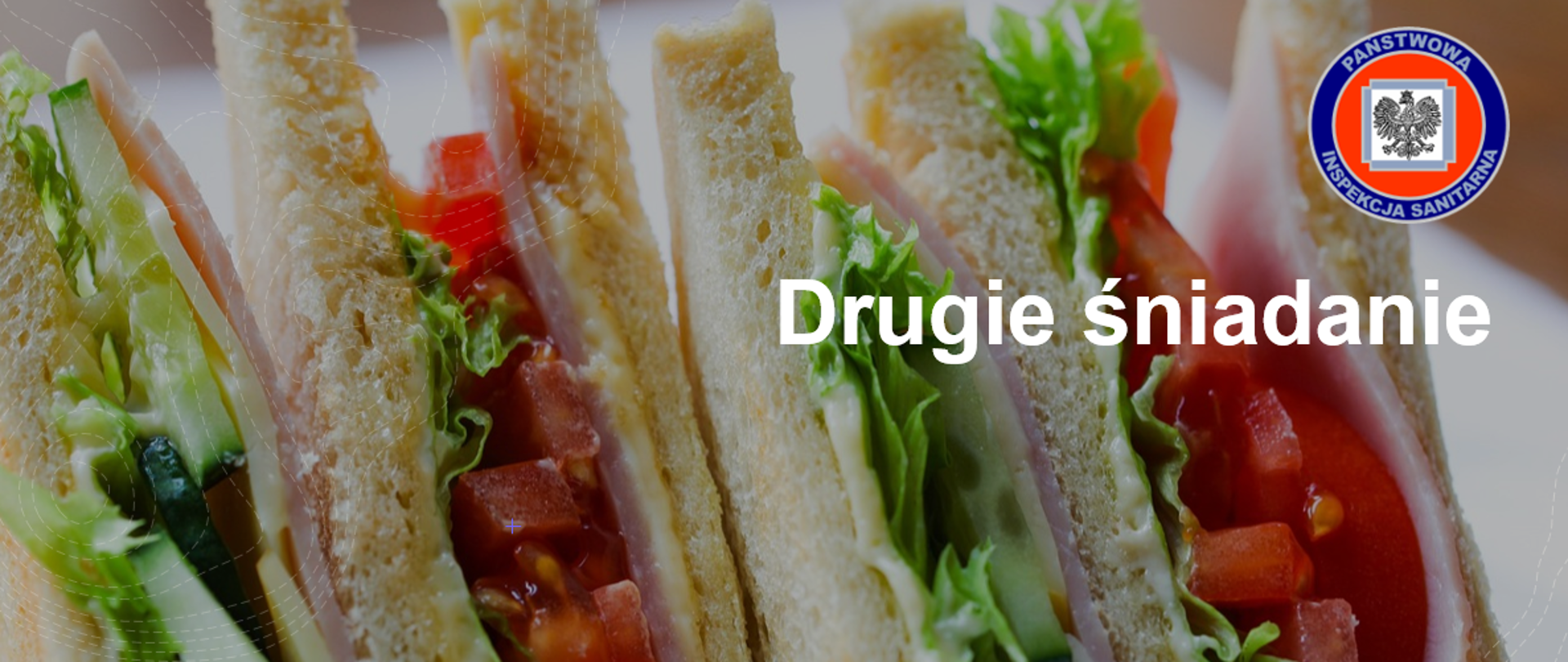 grafika przedstawia kanapki, hasło tematyczne - drugie śniadanie oraz logo Inspekcji Sanitarnej