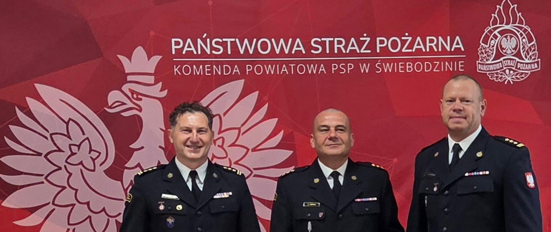 Zdjęcie przedstawia kierownictwo komendy starszego brygadiera Mariusza Wójcika i starszego brygadiera Marcina Bohuszko z kapitanem Krystianem Hoppe z okazji jubileuszu 25 lat służby.
