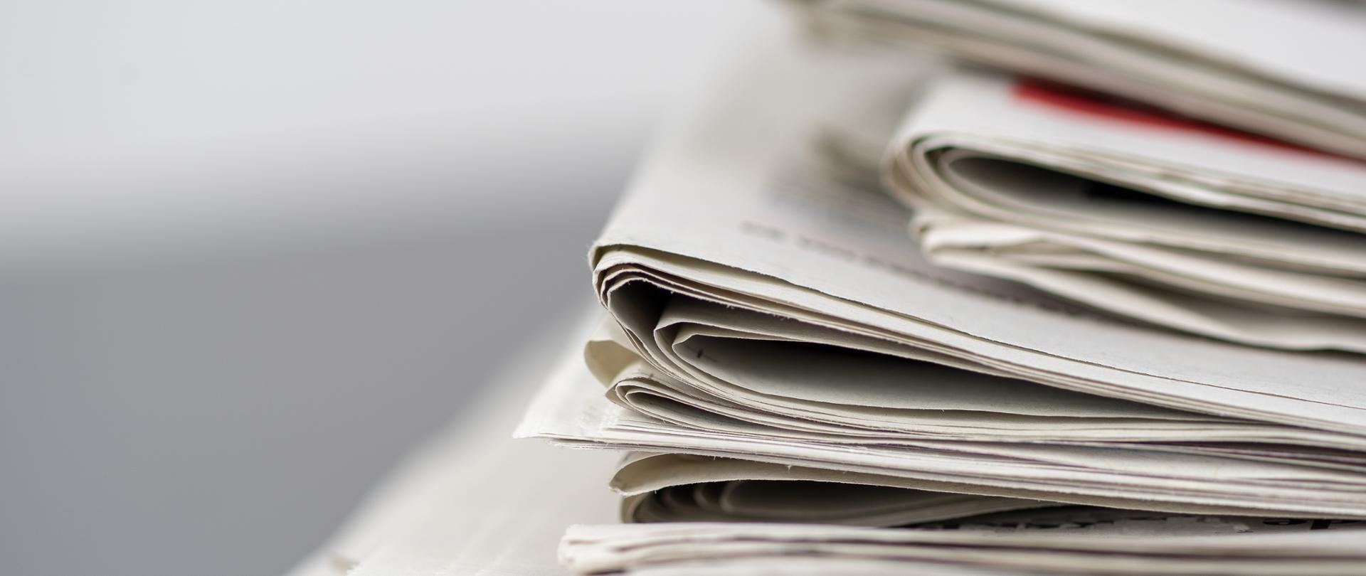 A closeup shot of several newspapers stacked on top of each other